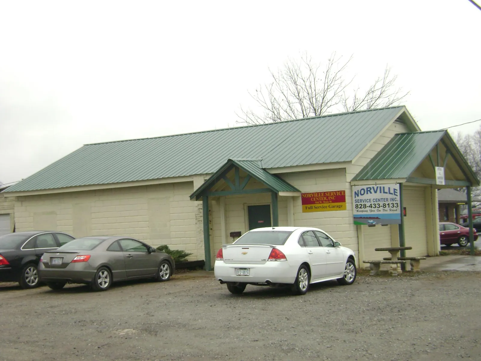 Green metal roof on a service garage with a covered entry in Howard Lake